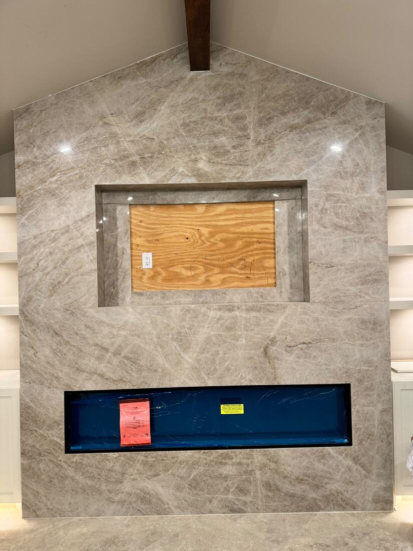 Floor-to-peak quartzite fireplace and media wall, cut from large slabs
