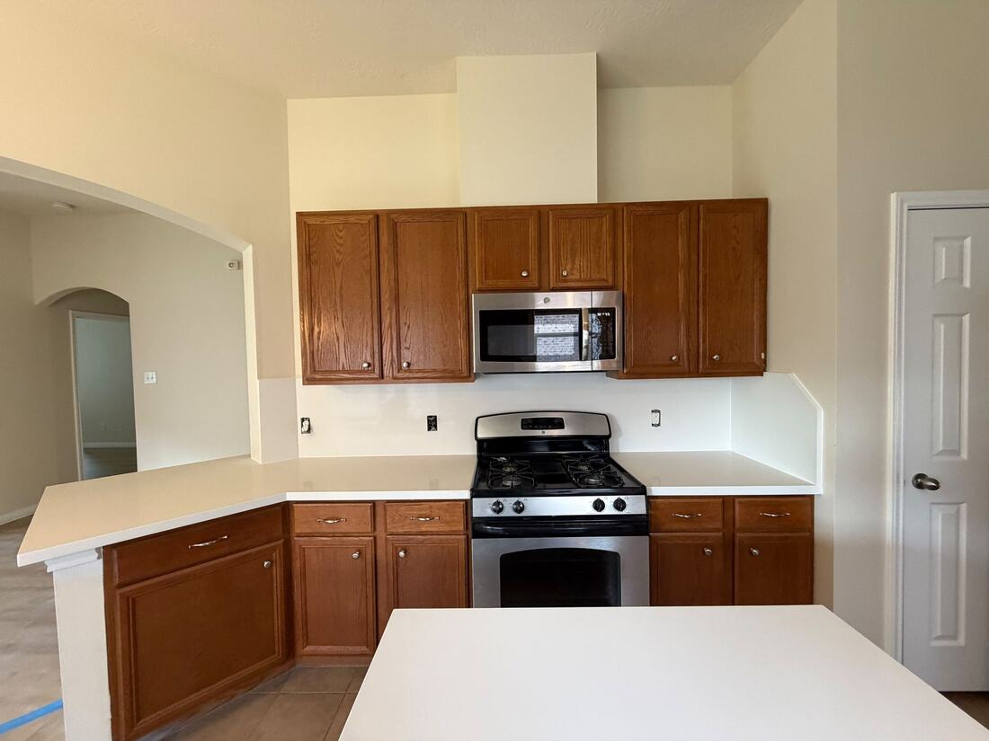 Kitchen remodel with oak cabinets and new white quartz counters
