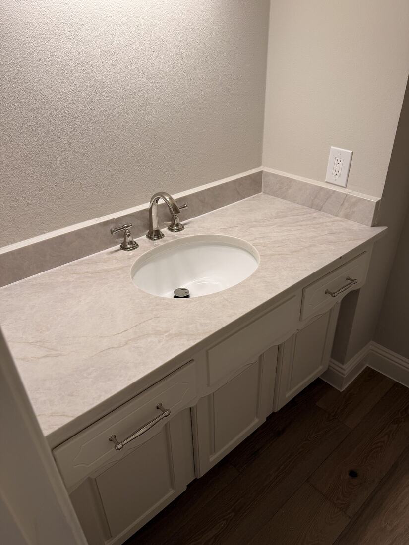 Powder room vanity with a soft quartzite top and matching backsplash